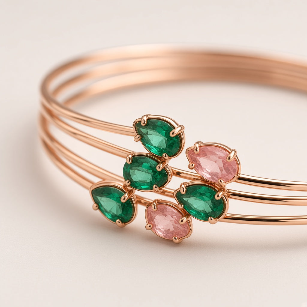 Lalit Rose Gold Wire Cuffs - close-up of pear-cut emerald and blush stones on fine rose gold wires