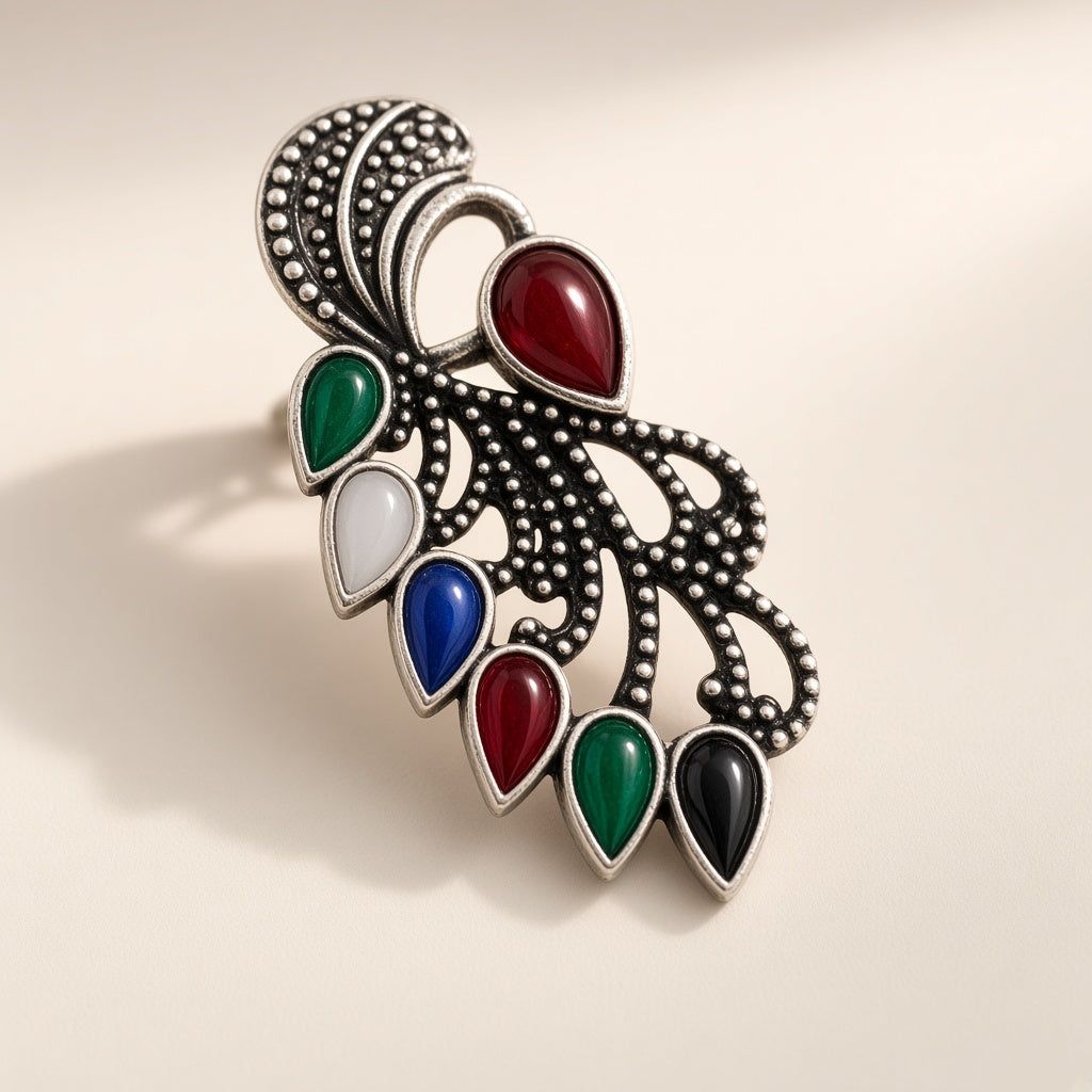 Mor oxidised peacock earrings, close-up of the engraved silver and teardrop stones