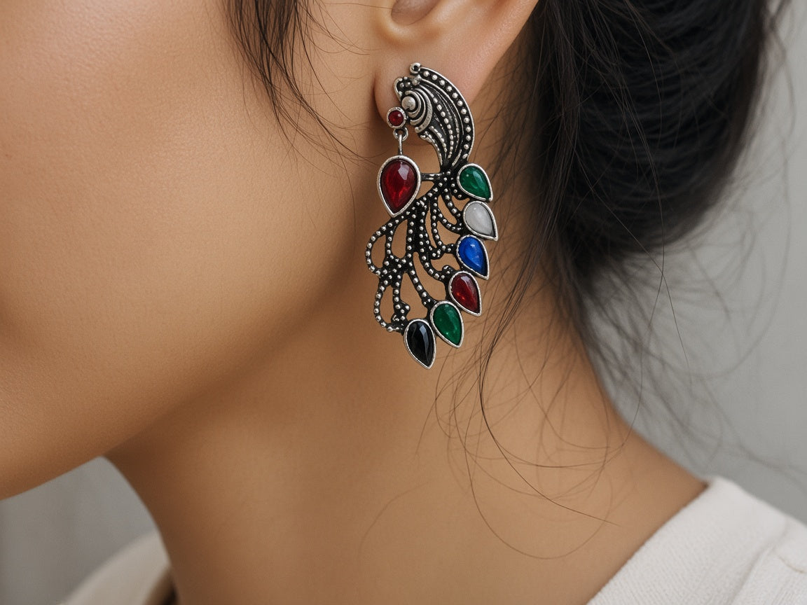 Mor oxidised peacock earrings worn on the ear