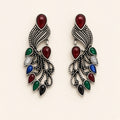 Mor oxidised silver peacock earrings with coloured stones, studio shot on cream background
