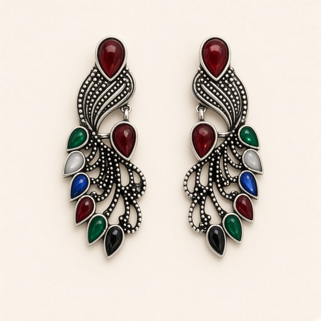 Mor oxidised silver peacock earrings with coloured stones, studio shot on cream background