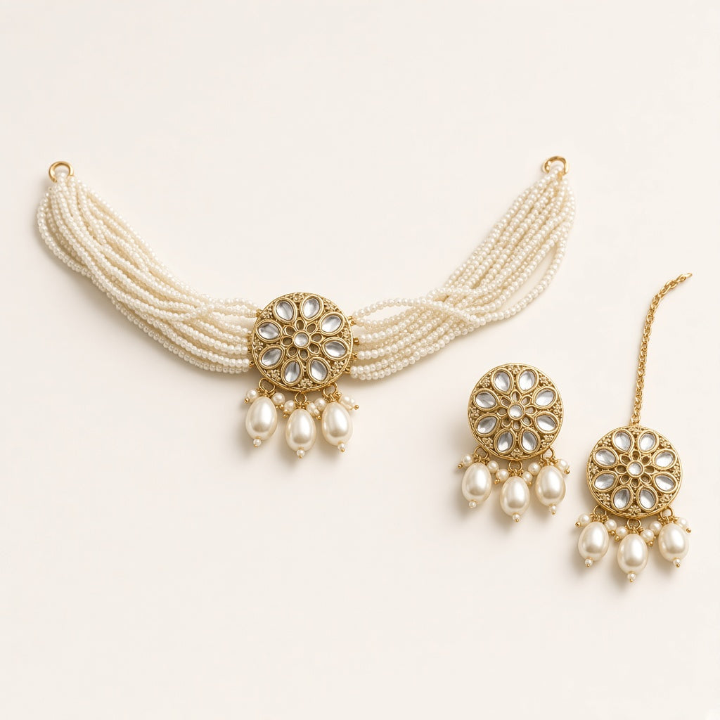 Moti pearl kundan choker set with earrings and maang tikka, studio shot on cream background