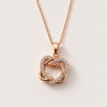 Prem rose-gold-tone interlocking hearts pendant necklace, one polished and one pavé heart, studio shot
