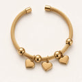 Pyaar twisted cable cuff bracelet with three heart charms, studio shot