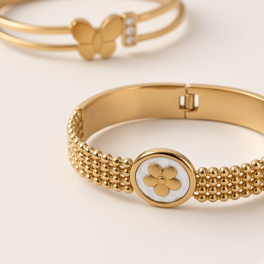 Sakhi Clover Mesh bangle close-up with white clover medallion, Butterfly cuff behind