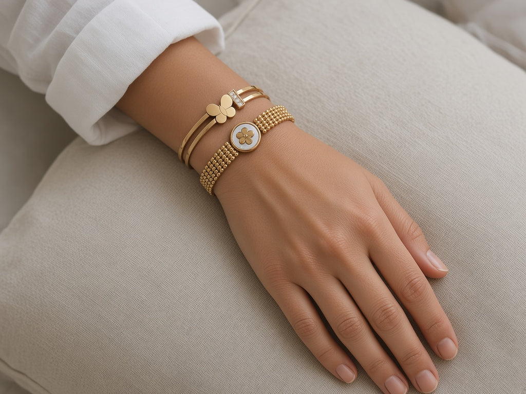 Sakhi Butterfly and Clover Mesh bangles stacked on the wrist