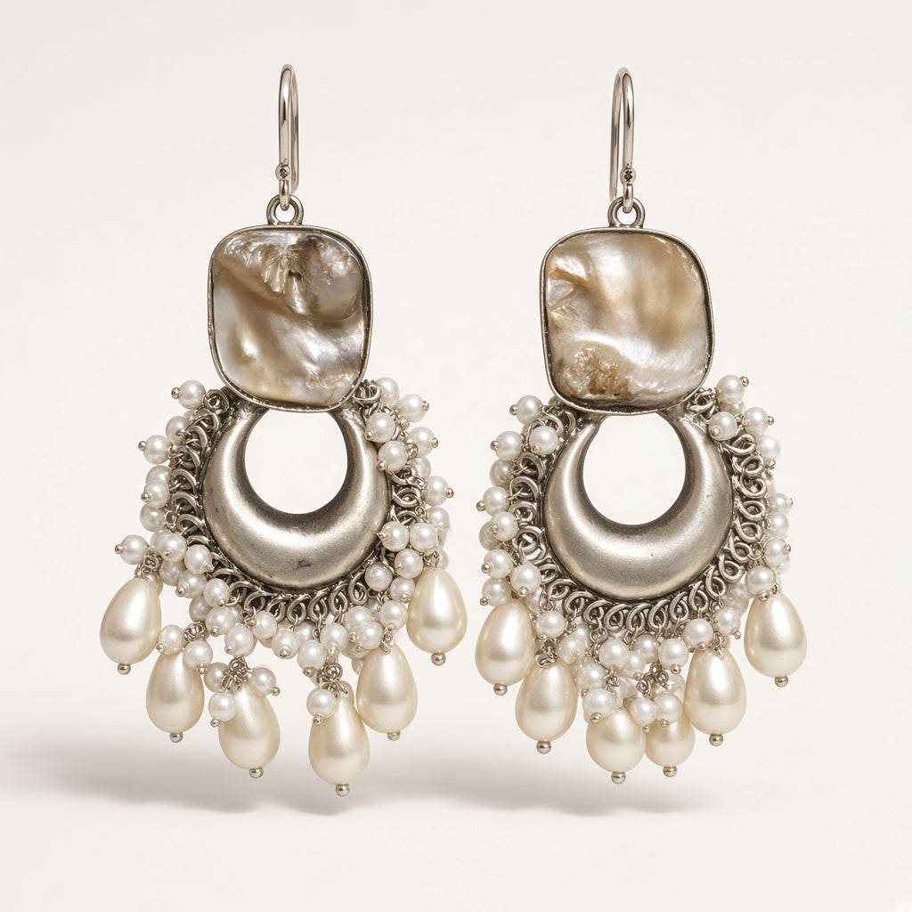 Seep silver-tone pearl chandbali earrings with baroque shell-look top and pearl fringe, studio shot