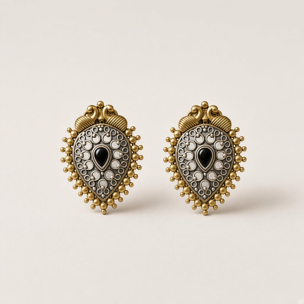 Shyama two-tone oxidised peacock teardrop studs with black centre stone and gold beaded border, studio shot