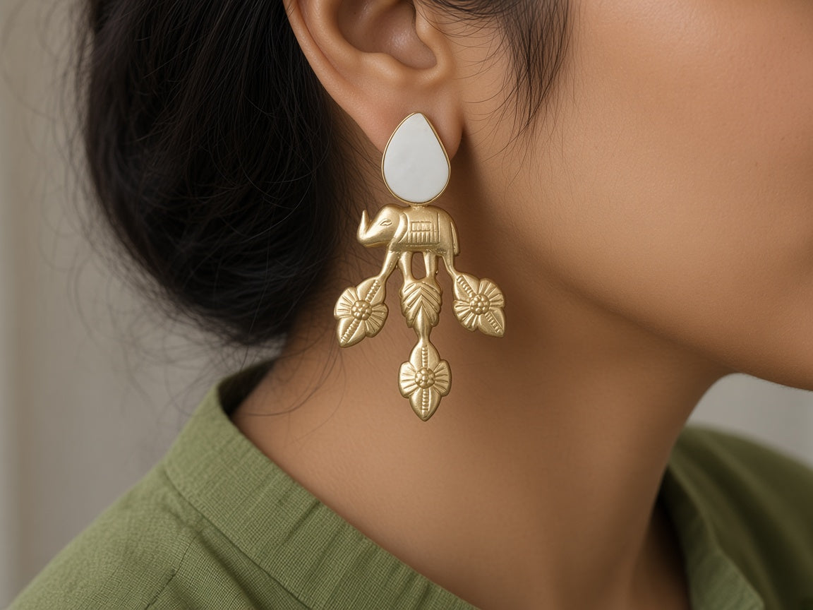 Vana matte gold elephant earring worn on the ear