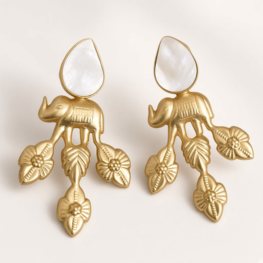 Vana matte gold elephant earrings with mother-of-pearl-look teardrop and carved leaf drops, studio shot